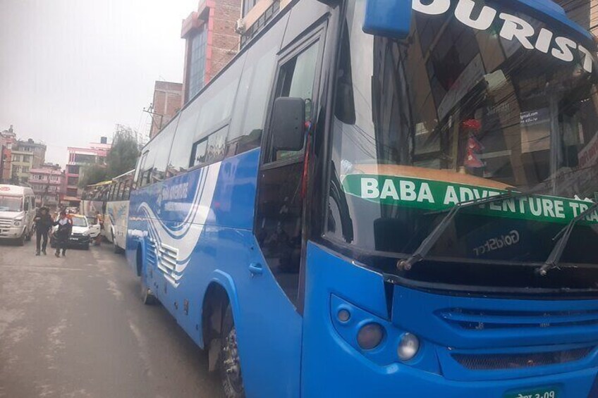 A blue bus with "BABA ADVENTURE TRAIL" on the windshield. 5