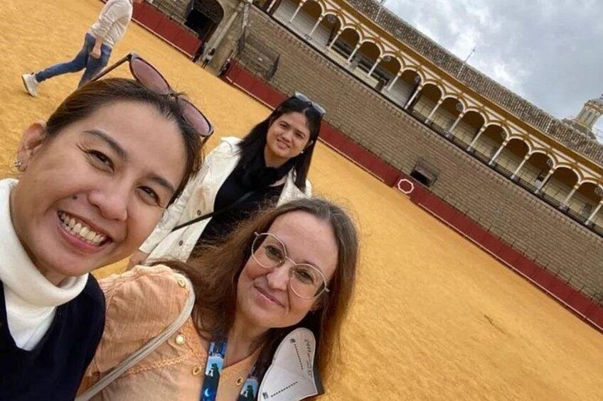 Tres personas tomándose un selfie con un edificio histórico al fondo. 4