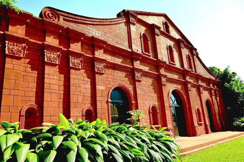 A red brick building with arched windows and a curved roof. 1