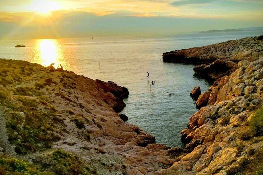 A coastal landscape with rocky cliffs, calm sea, and a boat in the distance. 4