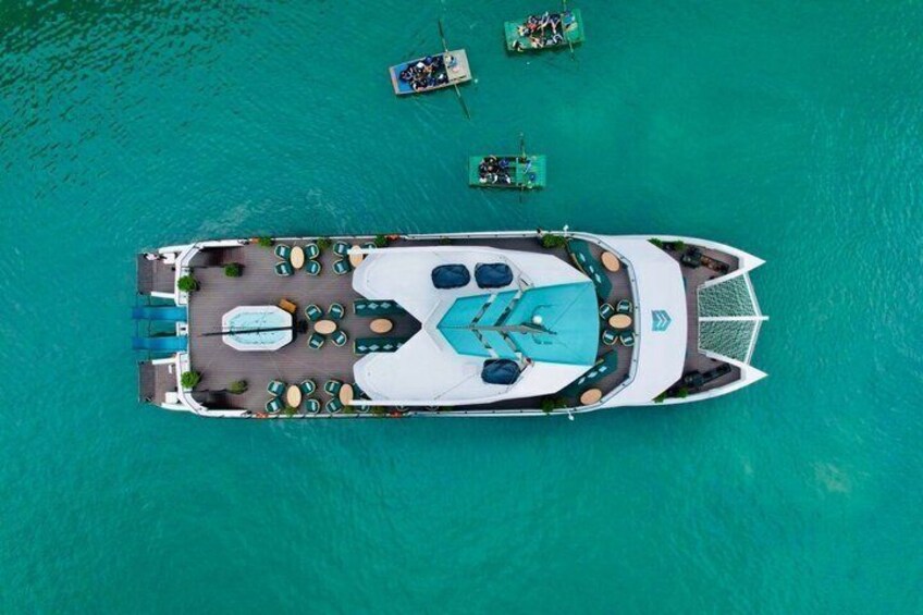 Un bote amarrado en aguas turquesas con sillas de descanso y una zona para nadar. 5