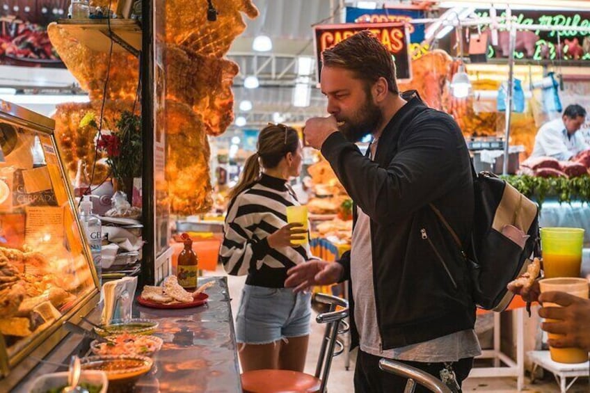 A person at a food stall with various dishes and a sign that reads 'CAFEAS.' 3