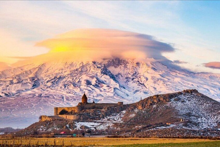 A snow-covered mountain with a castle-like structure in the foreground. 3