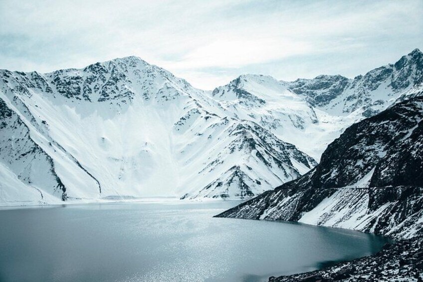 A snow-covered mountain landscape with a lake. 1