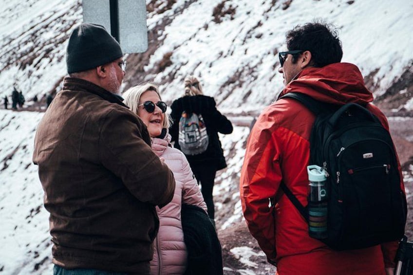 A group of people standing on a snowy mountain slope. 4