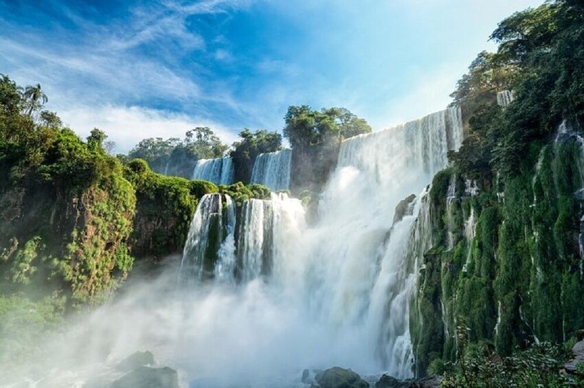 A multi-tiered waterfall surrounded by lush greenery. 4
