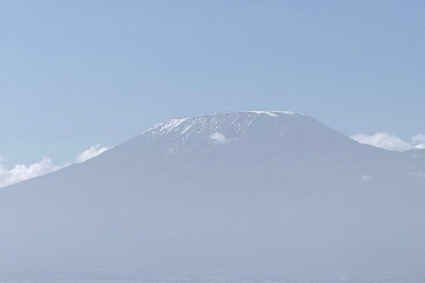 A snow-capped mountain under a clear sky. 5