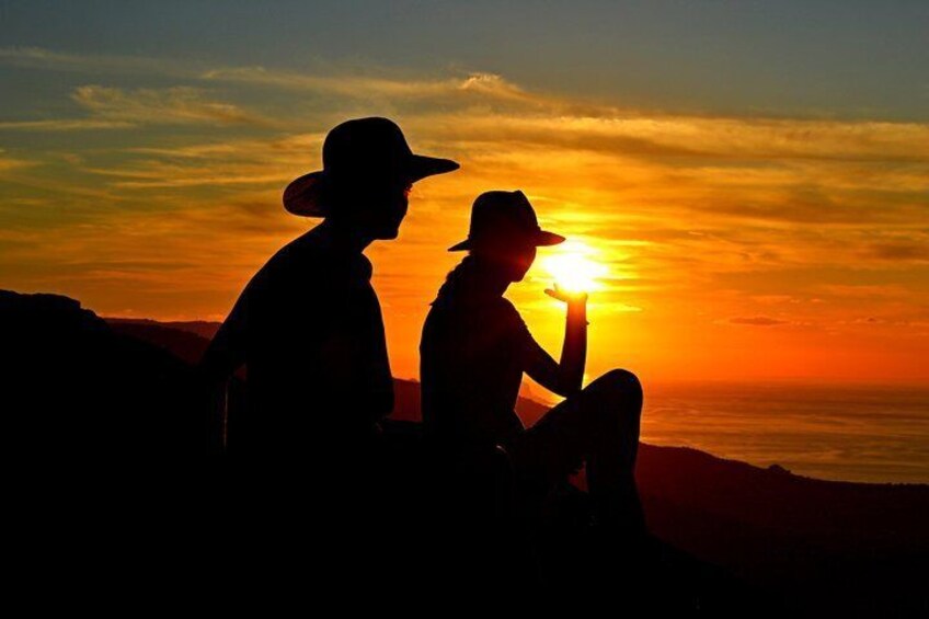 Two people silhouetted against a sunset. 5