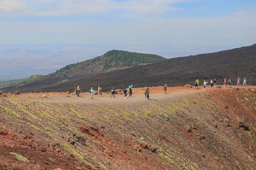 A group of hikers on a dirt path in a hilly landscape. 2