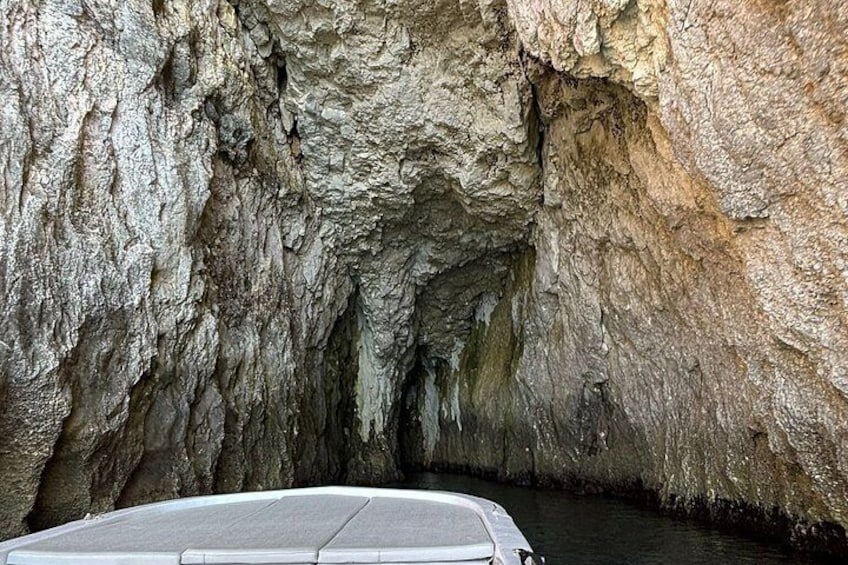 A cave with a boat in the foreground. 3