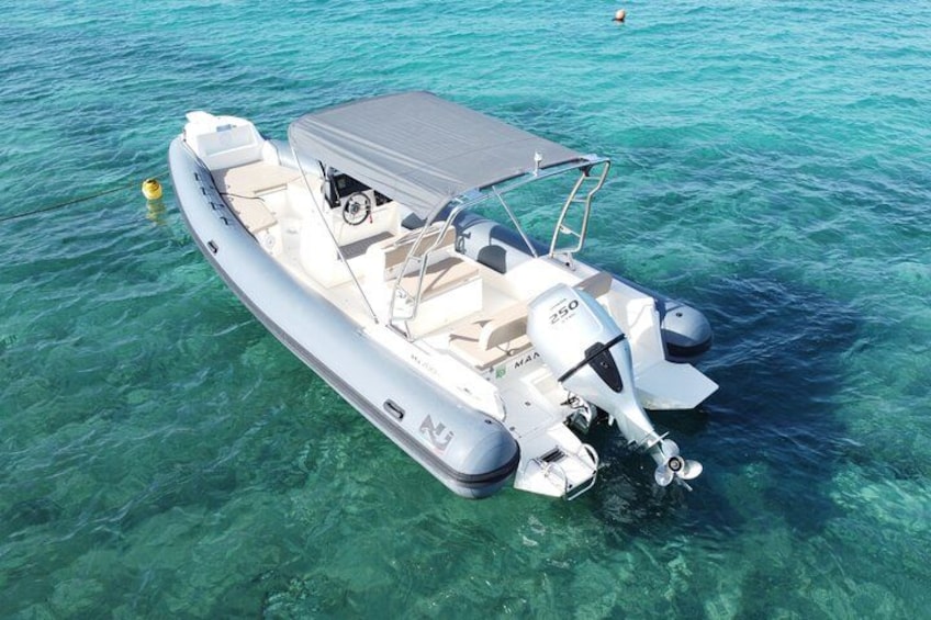 A motorboat on clear turquoise water. 3