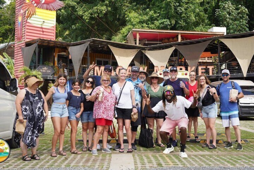A group of people posing in front of a restaurant with a sign that reads "MARTINI." 1
