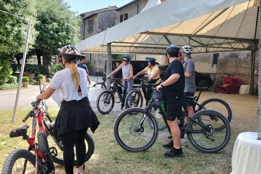 A group of people with bicycles near a tent. 2