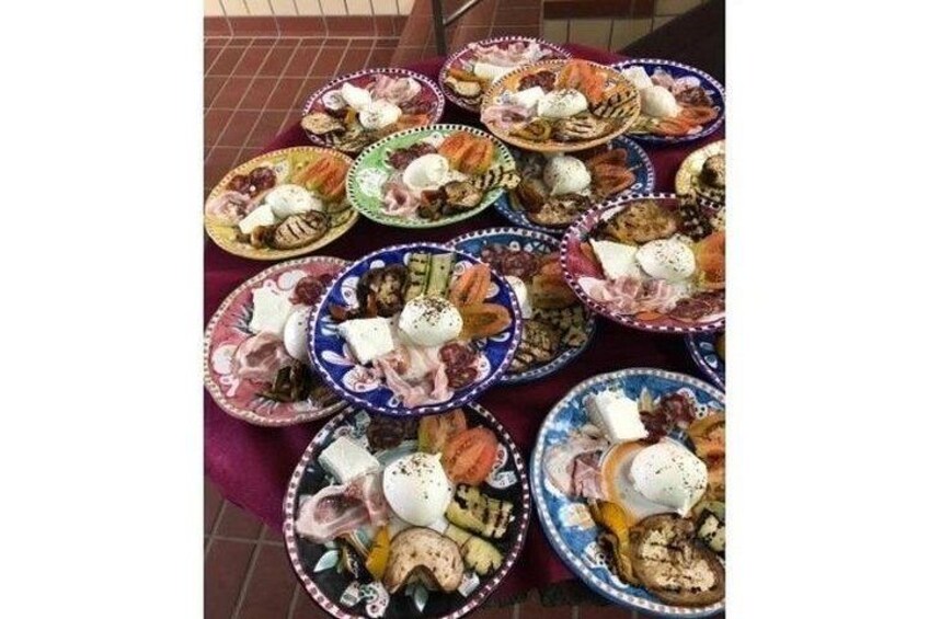 A table with multiple colorful plates of food, including cheese, meats, and vegetables. 4