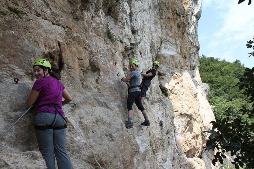 Two people rock climbing on a rocky cliff. 1