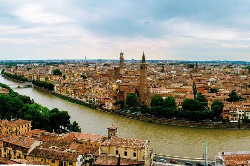A river flowing through a city with historic buildings and a prominent tower. 2