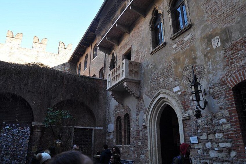 A historic building with arched windows and a balcony. 4