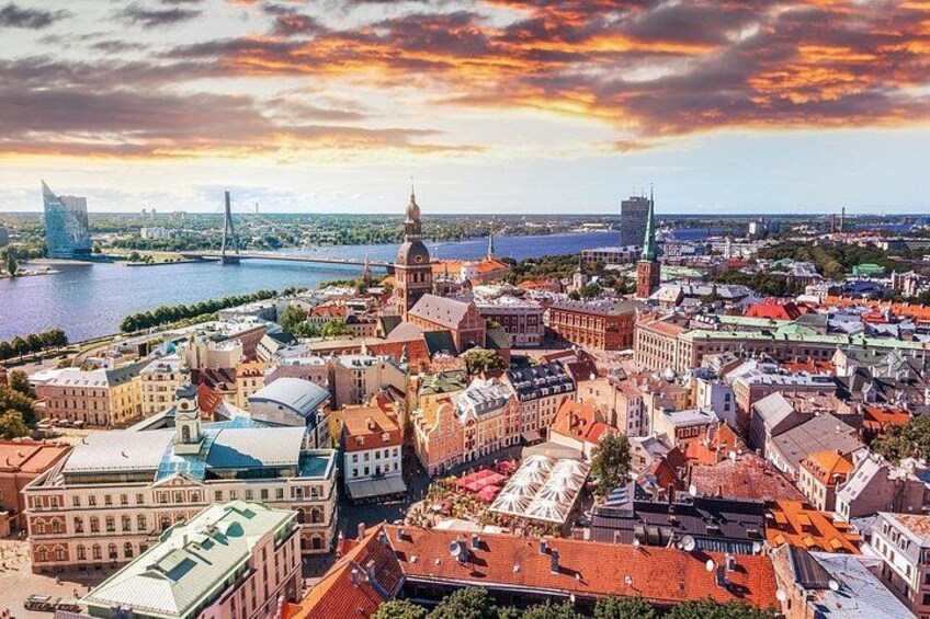 A cityscape with historic buildings, a river, and a modern bridge. 4