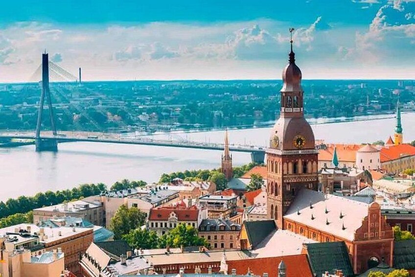 A cityscape with a prominent tower, a river, and a modern bridge. 2