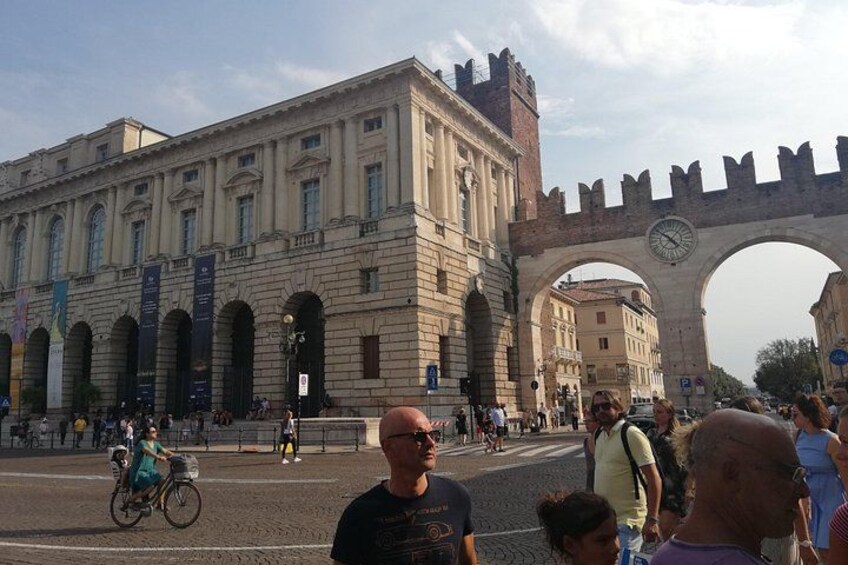 A historic building with arched windows and a large archway. 2