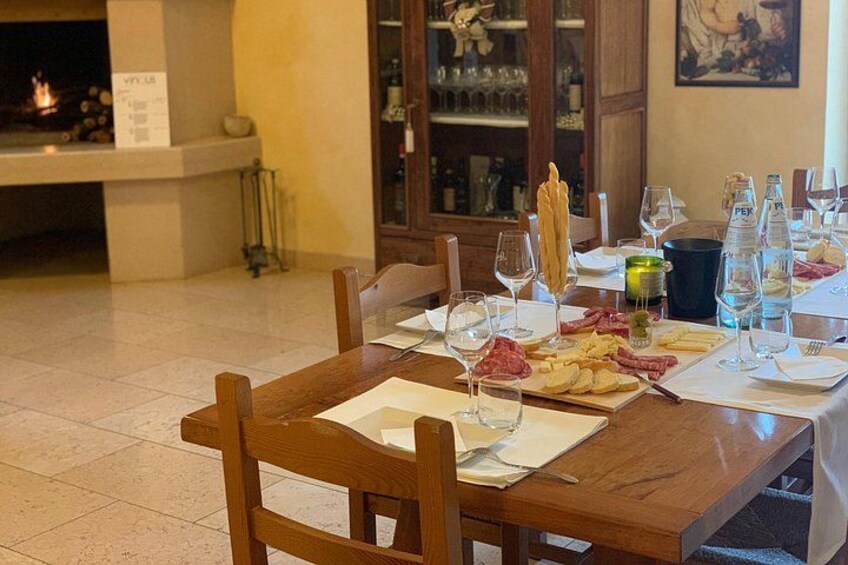 A dining table set with plates, glasses, and a bottle of water. 5