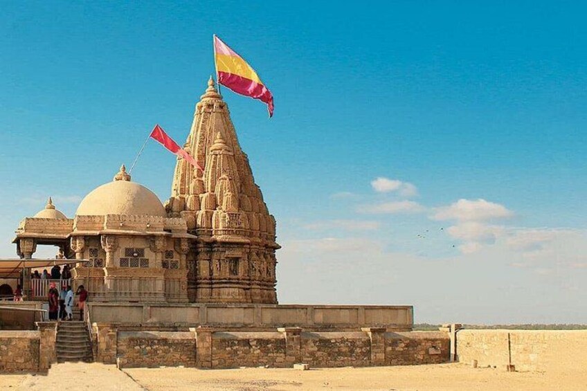 A temple with a flag, a dome, and a tall spire. 2