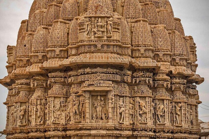 A detailed sandstone temple with intricate carvings and multiple spires. 5