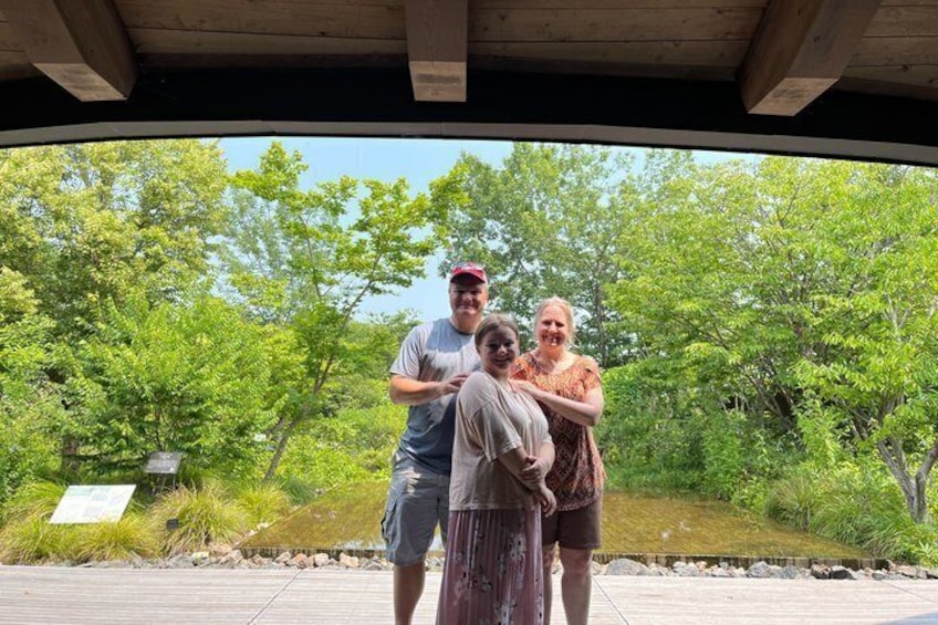 A wooden deck with people standing and embracing. 2
