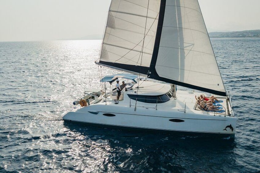 A sailboat with a large sail on the water. 2