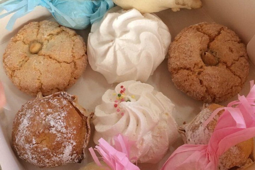 A box of assorted pastries including cookies and meringues. 2