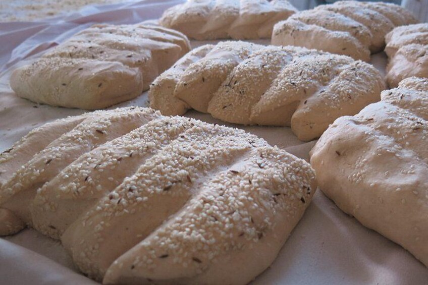 Loaves of bread with sesame seeds on a baking sheet. 4