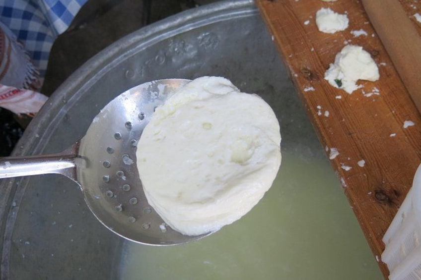 A ladle scooping a white substance from a container. 3