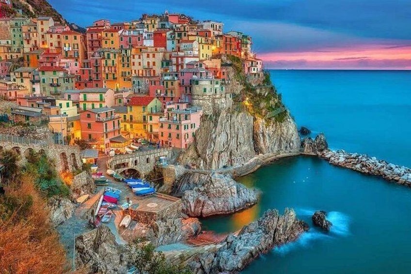A coastal town with colorful buildings perched on a cliff overlooking the sea. 3