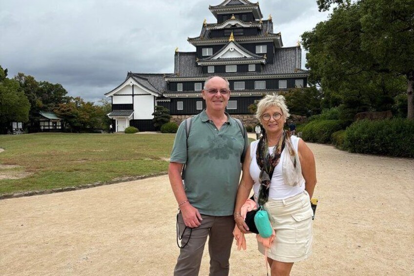 A historic building with traditional architecture, a paved pathway, and a grassy area. 1