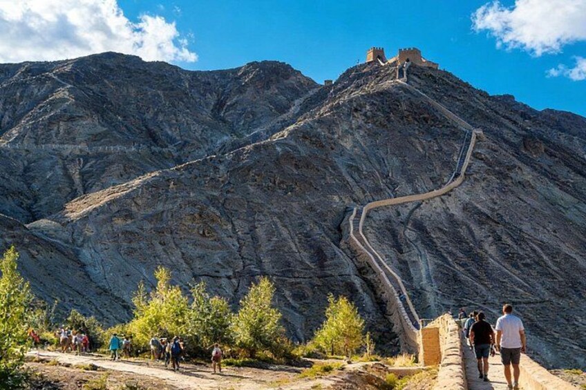 A mountain with a winding path and a castle on top. 4