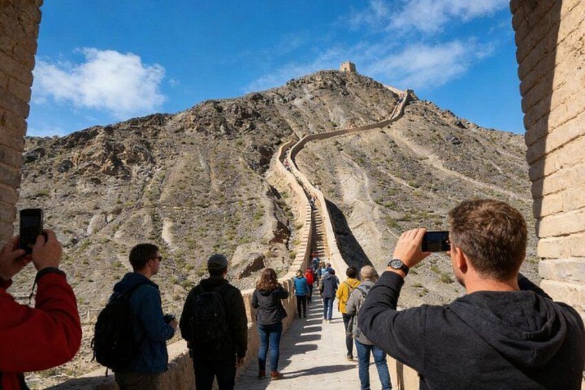 A group of people taking photos of the Great Wall of China. 2