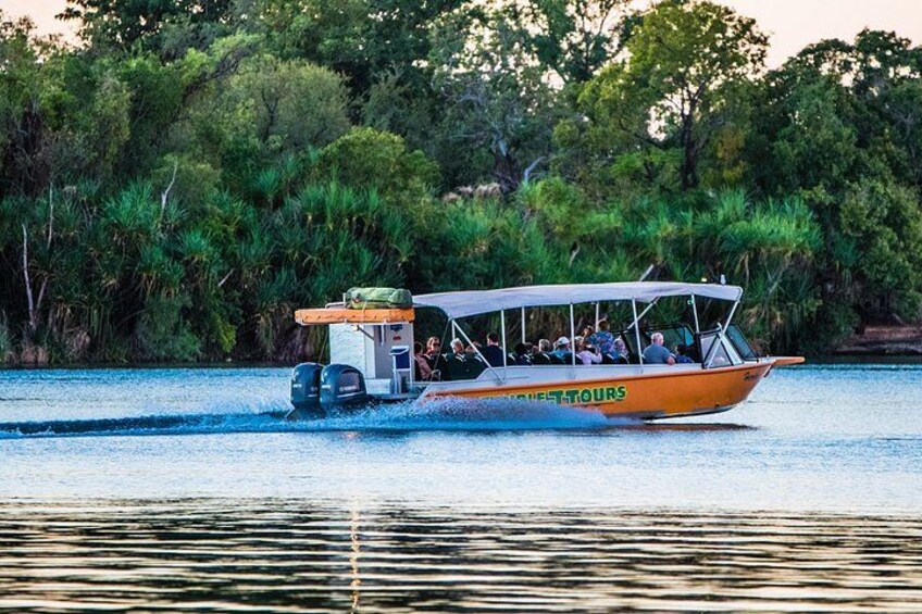 A boat with passengers on a river surrounded by dense greenery. 2