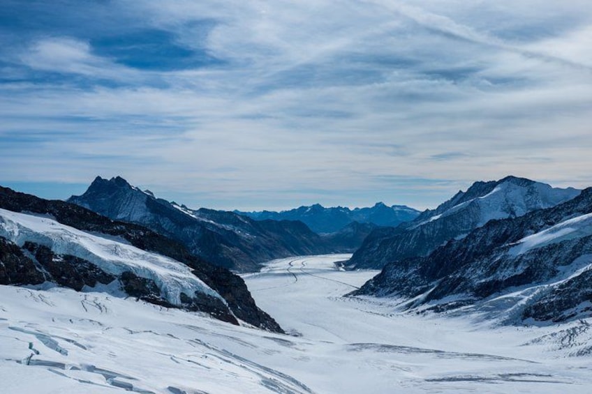 A snow-covered mountain range with a glacier and a valley. 3
