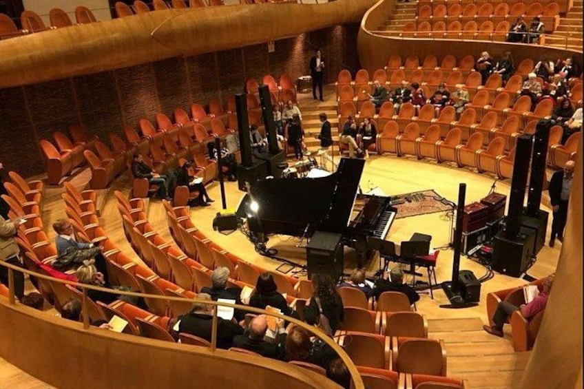 Un auditorio con escenario, asientos e instrumentos musicales. 1