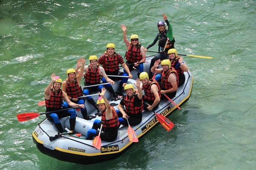 A group of people in a raft on a body of water. 2