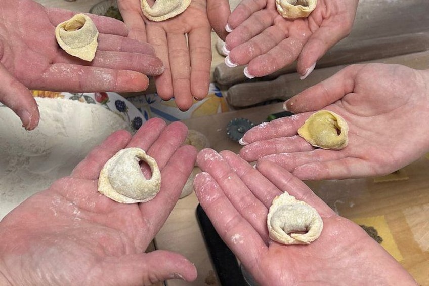 Hands holding dumplings. 4