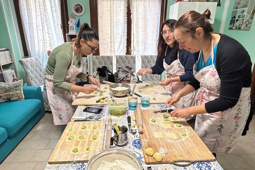 A group of people preparing food in a kitchen. 5