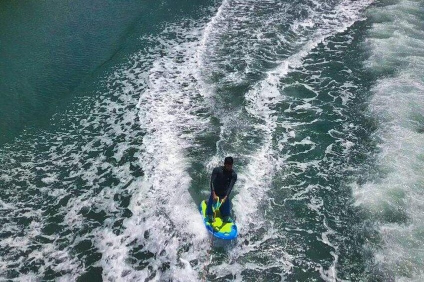A person riding a jet ski on a body of water. 5