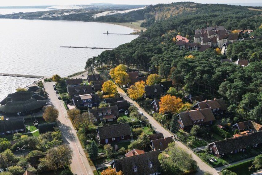 A coastal village with houses, a bridge, and a river. 1