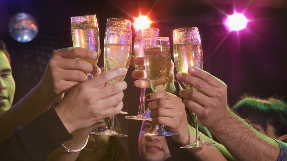 People raising their champagne glasses at a Las Vegas Club Crawl  2