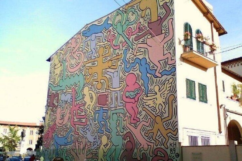 A colorful mural with abstract figures and patterns on a building. 2
