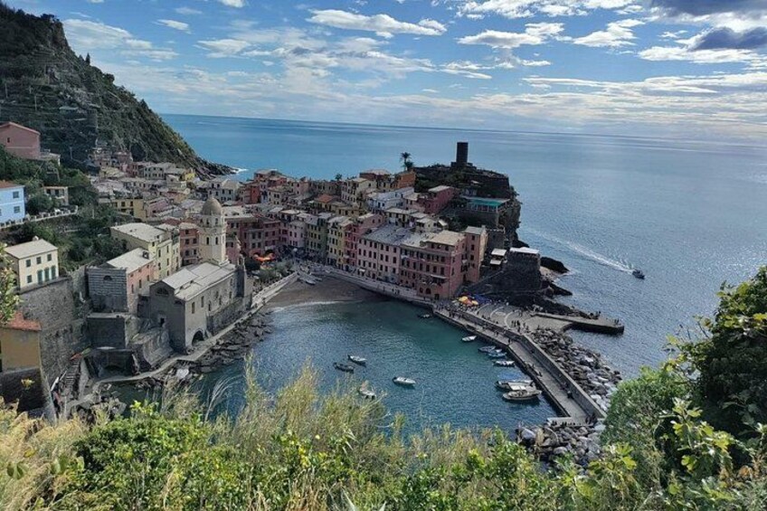 A coastal town with historic buildings, a harbor, and boats. 3
