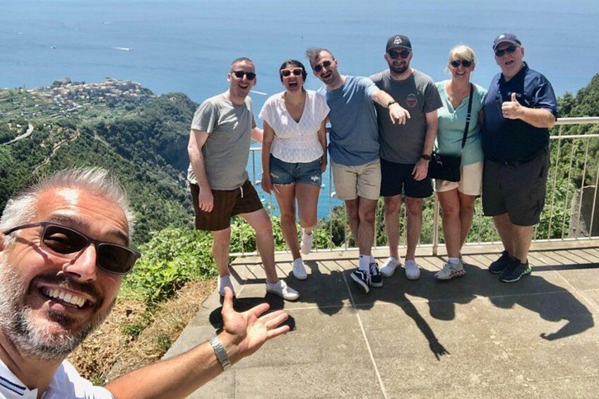 A group of people standing on a viewing platform with a scenic overlook. 4