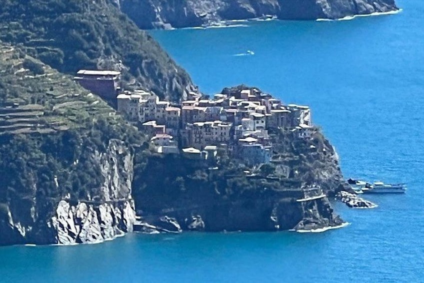 A coastal village built on a cliff, with buildings closely packed together. 3
