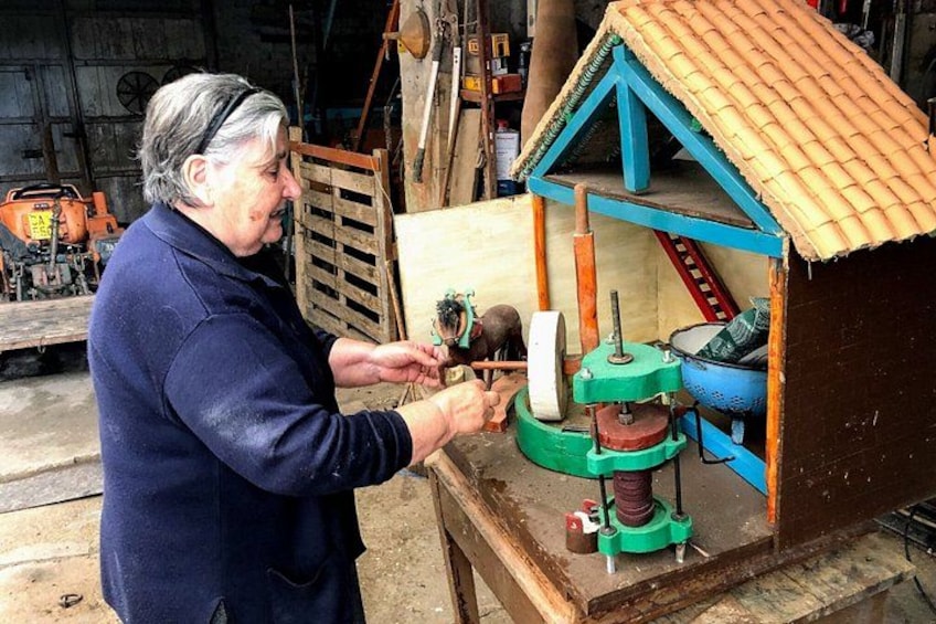 A person operating a mechanical device with a house-shaped structure. 2